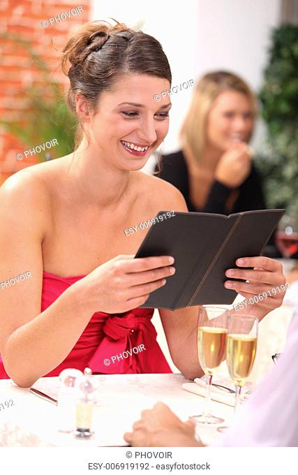 woman looking at the menu at a restaurant