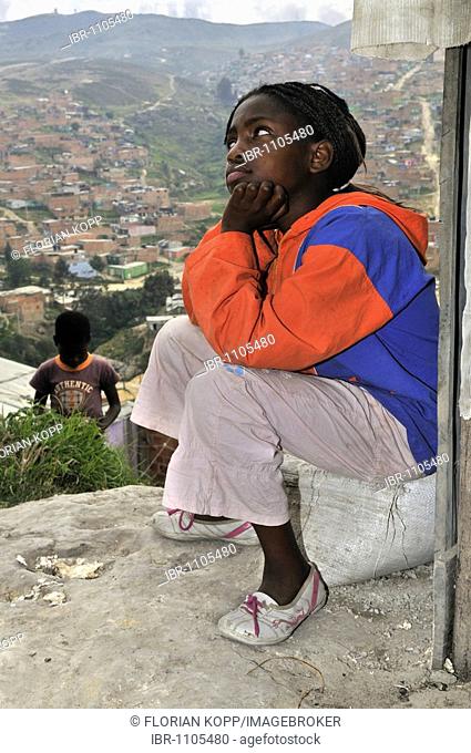 Thoughtful dark-skinned girl, 11 years old, slums of Alto de Cazuca, Soacha, Bogotá, Columbia