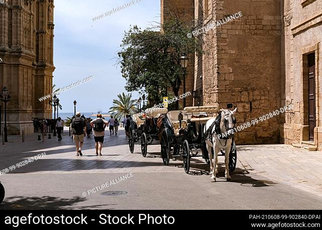 01 June 2021, Spain, Palma: Carriages were at La Seu Cathedral waiting for tourists to be driven through the city. Photo: Jens Kalaene/dpa-Zentralbild/ZB