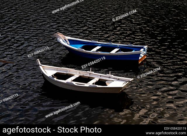 Pretty colorful boats in the dark waters of the Xallas River Estuary on the coast of Galicia