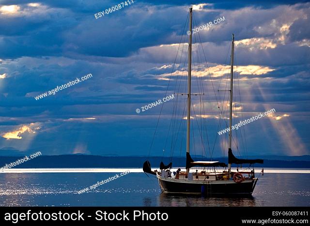 A sailboat on a calm sea at dusk, BC, Canada