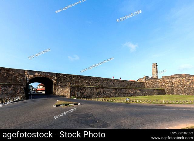 Galle, Sri Lanka - July 29, 2018: The historic Clock Tower and people walking on the city wall