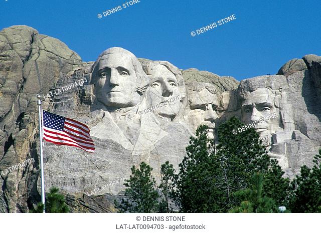 Keystone. Likenesses of four American presidents, Washington, Jefferson, Lincoln, Roosevelt. Flag