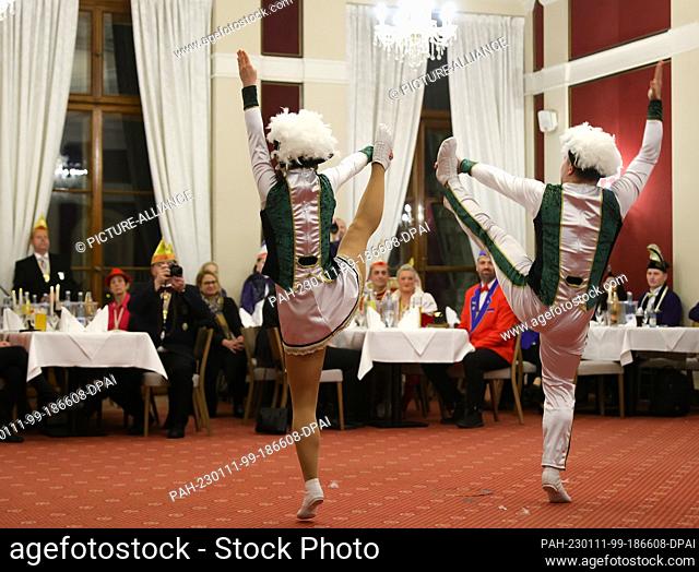 11 January 2023, Mecklenburg-Western Pomerania, Schwerin: Carnivalists dance in front of guests during the reception of the president of the...