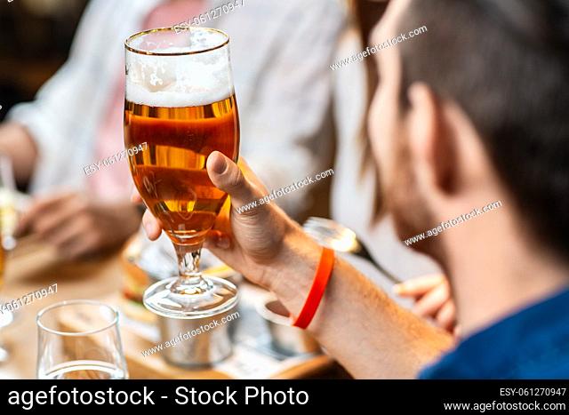 close up of man drinking beer at restaurant or pub
