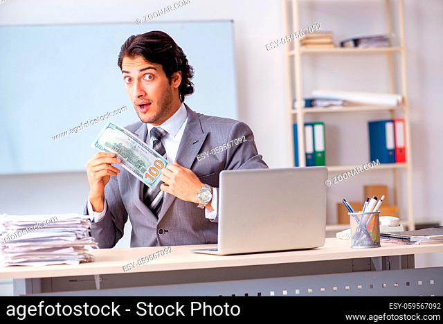 Young handsome businessman employee sitting in the office