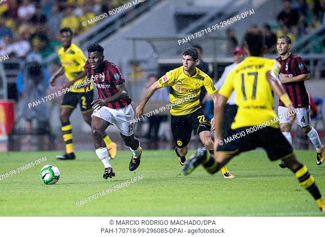 Dortmund's Christian Pulisic (r) and Milan's Franck Kessi (l) in action during the international club friendly soccer match between AC Milan and Borussia...