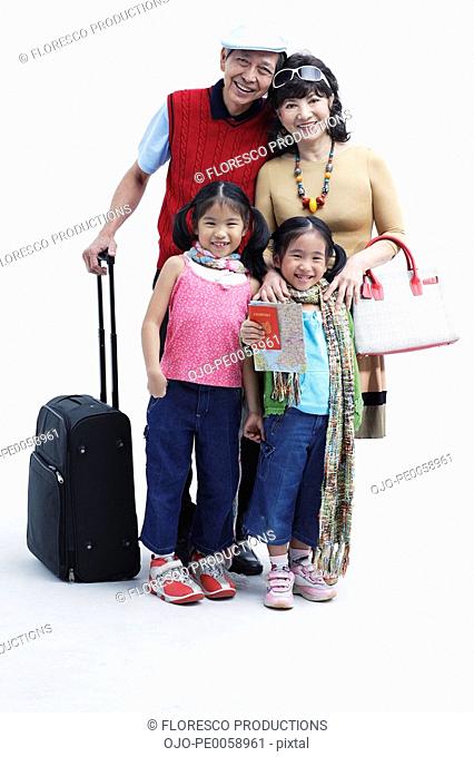 Couple with two young girls and luggage