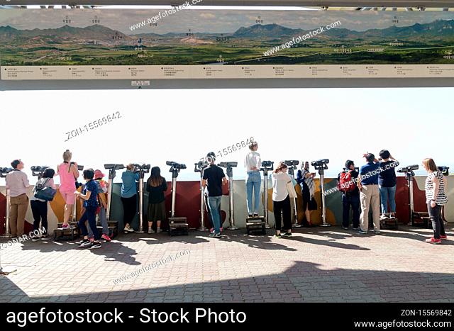 Dora Observatory, DMZ, South Korea - September 8 2017: Tourists watching with binoculars to North Korean village Propaganda village or Peace village at Korean...