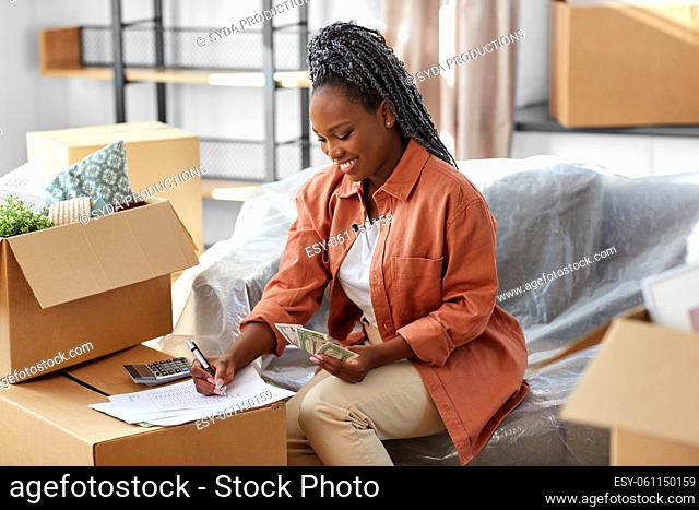 happy woman moving to new home and counting money