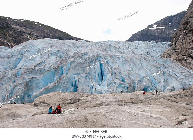 tourists in front of Nigardsbreen glacier tongue , Norway, Jostedalsbreen National Park