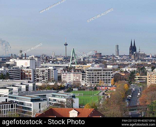 22 November 2023, North Rhine-Westphalia, Cologne: Panorama of Cologne, in the foreground a housing estate and the Severinsbrücke (aerial view with drone)