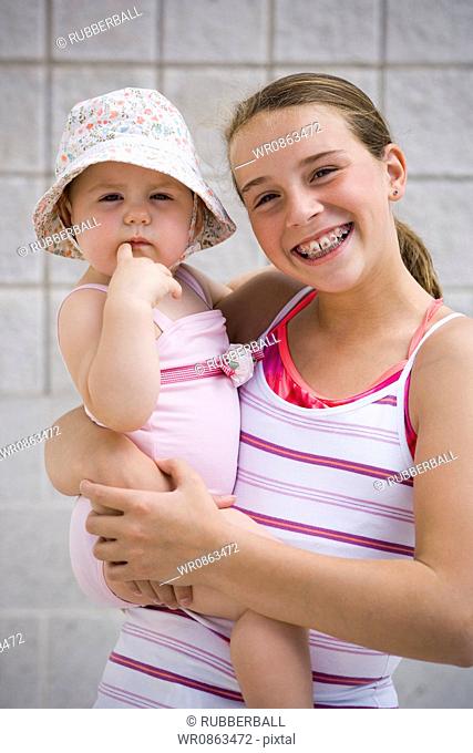 Girl holding baby