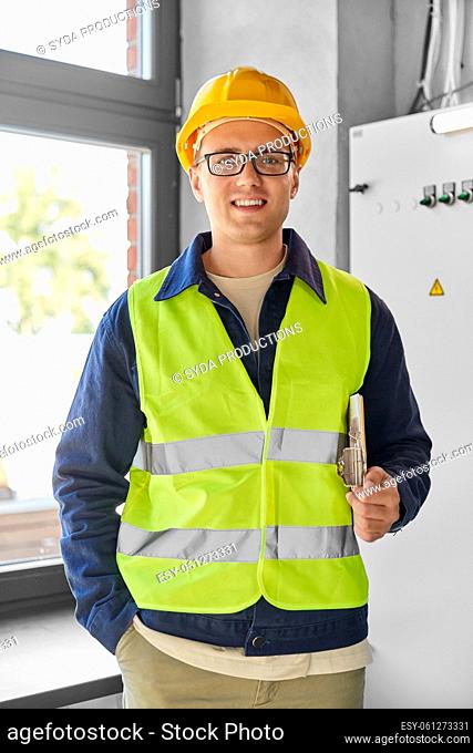 electrician with clipboard at electric board