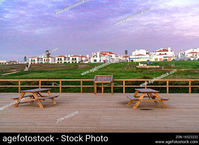 Porto Covo, Portugal - 20 December 2020: the scenic viewpoint on the Alentejo coast with the town of Porto Covo behind at sunset