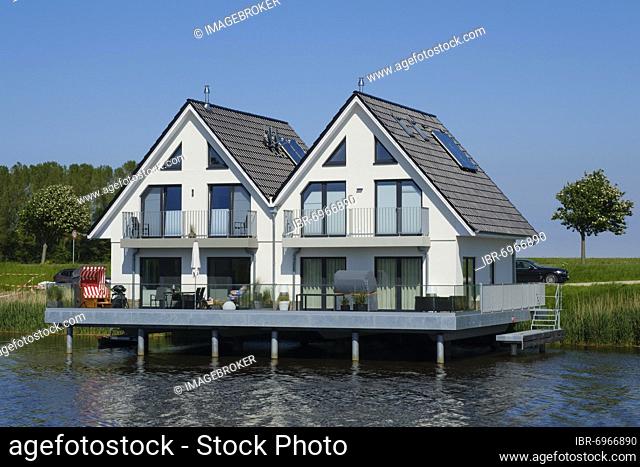 Pile houses on the river Harle, Harlesiel, Carolinensiel, East Frisia, Lower Saxony, Germany, Europe