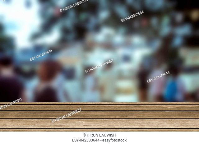 wood table top and Abstract Blurred Festival food night market. Can be used for display or montage your products