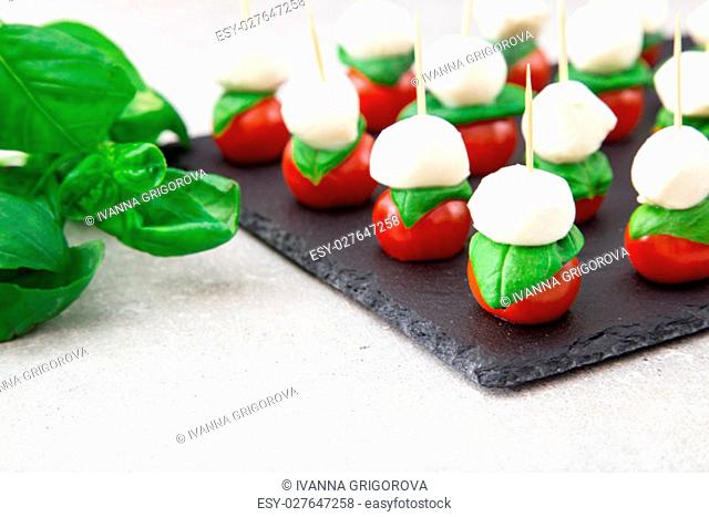 Caprese salad. Skewers with tomato and mozzarella with basil