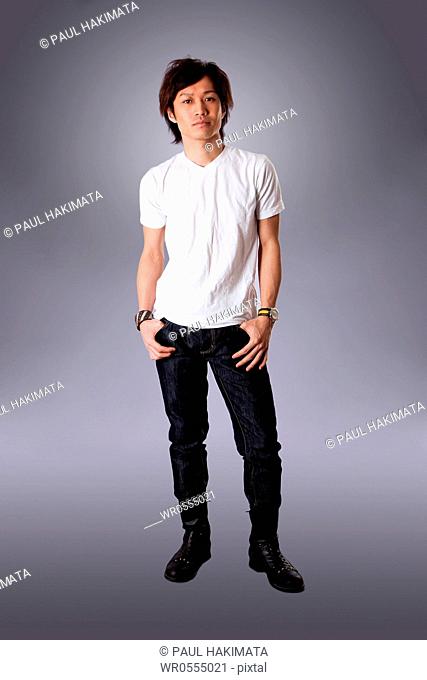 Casual Asian man wearing white shirt and jeans standing, isolated