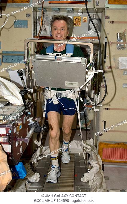 Canadian Space Agency astronaut Robert Thirsk, Expedition 20 flight engineer, equipped with a bungee harness, exercises on the Treadmill Vibration Isolation...