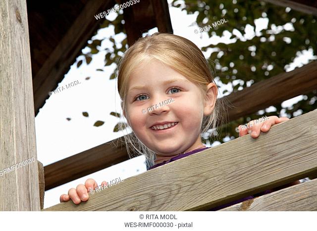 Germany, Bavaria, Huglfing, Girl in garden, smiling, portrait