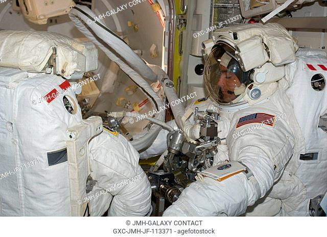 Astronauts Tom Marshburn (left) and Christopher Cassidy stand suited and almost ready to participate in the July 24 flight day 10 spacewalk