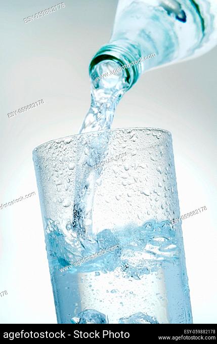 Mineralwasser wird in ein Glas eingeschenkt