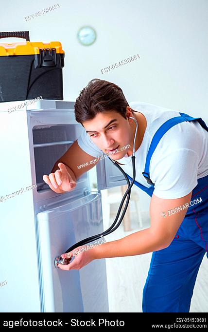 Repairman contractor repairing fridge in DIY concept