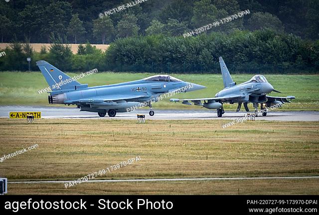 27 July 2022, Mecklenburg-Western Pomerania, Laage: Two Eurofighters taxi onto the runway at the air base for takeoff on a flight toward Estonia