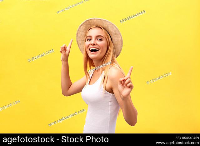 Young beautiful woman dancing in studio isolated on yellow background
