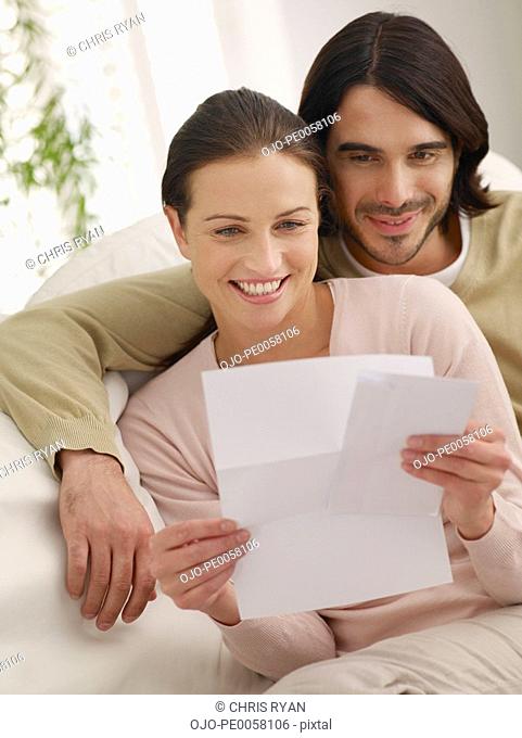 Couple looking at mail in living room