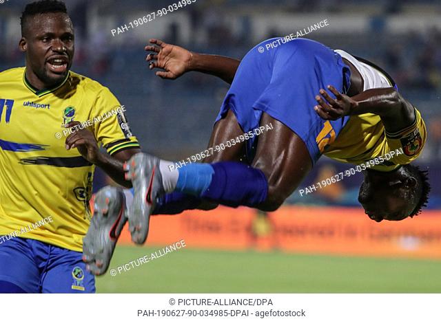 27 June 2019, Egypt, Cairo: Tanzania's Happygod Msuvan (R) celebrate scoring his side's first goal with his team mate Thomas Ulimwengu goal during the 2019...