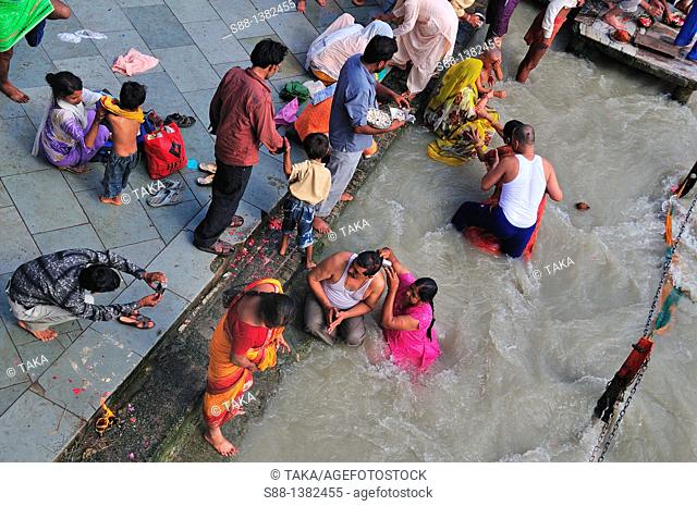 Pilgrims bathing and praying at Har Ki Pairi ghat by the Ganges River