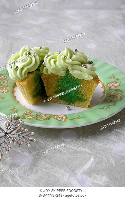 Vanilla Cupcake with a Green Tree Center and Green Frosting with Decorative Silver Balls; Halved