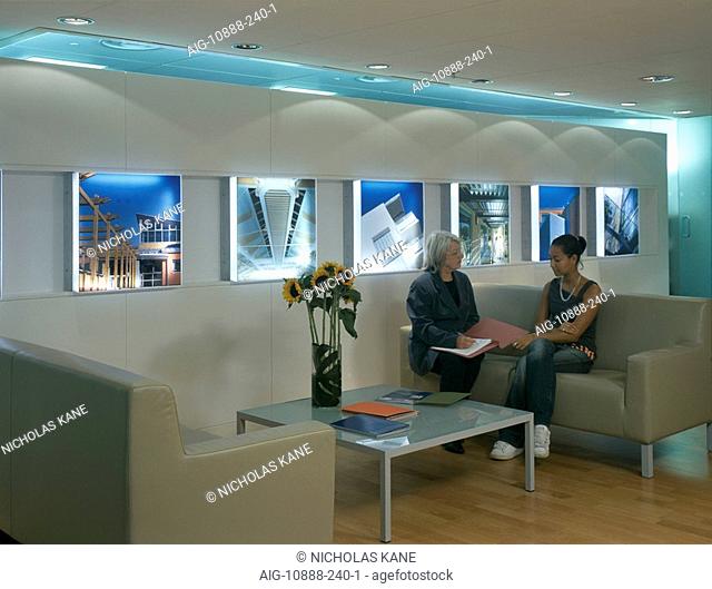 Office life and interiors. Two women in reception area