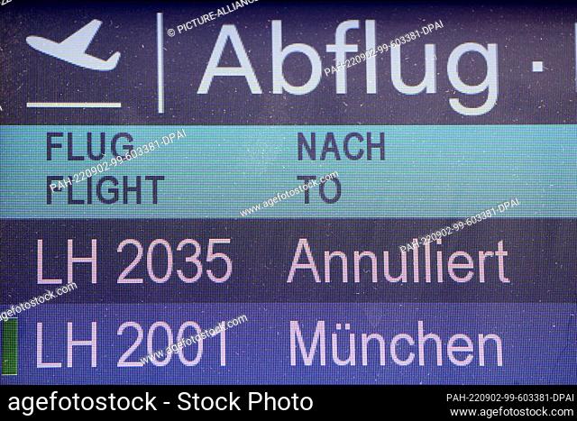 02 September 2022, North Rhine-Westphalia, Duesseldorf: Two cancelled Lufthansa flights are listed on a display board. Lufthansa is canceling almost its entire...
