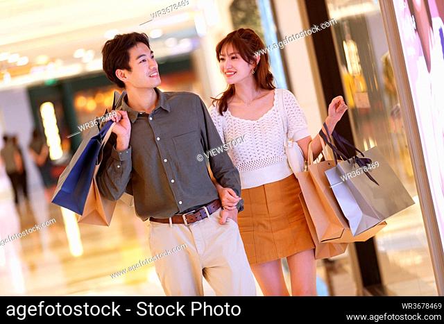 In the shopping mall is the happy couple