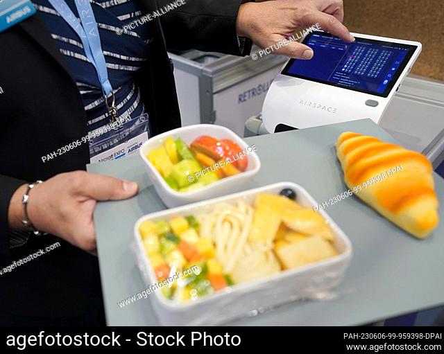 06 June 2023, Hamburg: An Airbus employee demonstrates a food scanner of an airspace cabin of the aircraft manufacturer Airbus at the Aircraft Interiors Expo...