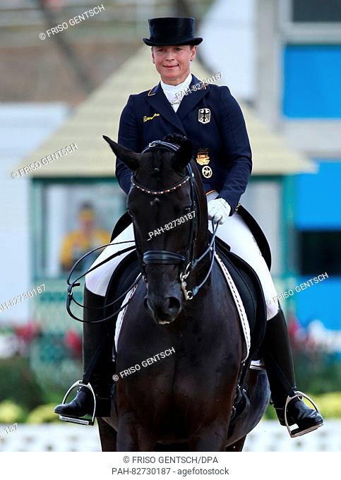 Isabell Werth of Germany on horse Weihegold Old smiles after performing during the Dressage Individual and Team Grand Prix Special of the Equestrian events...