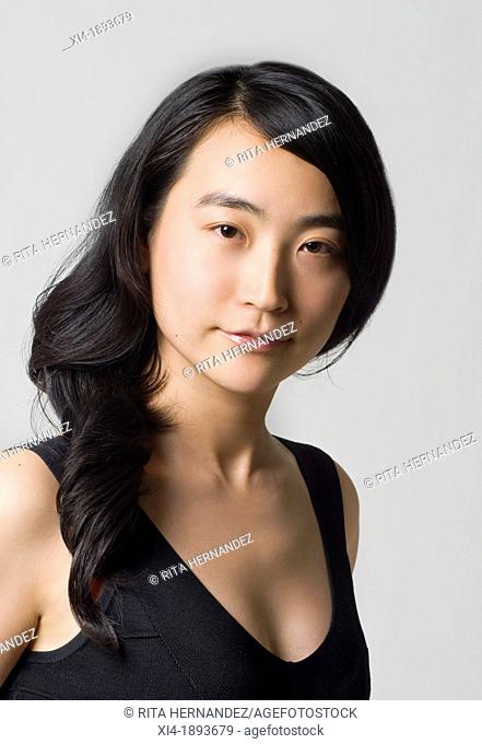 Asian young female looking into the camera  white background
