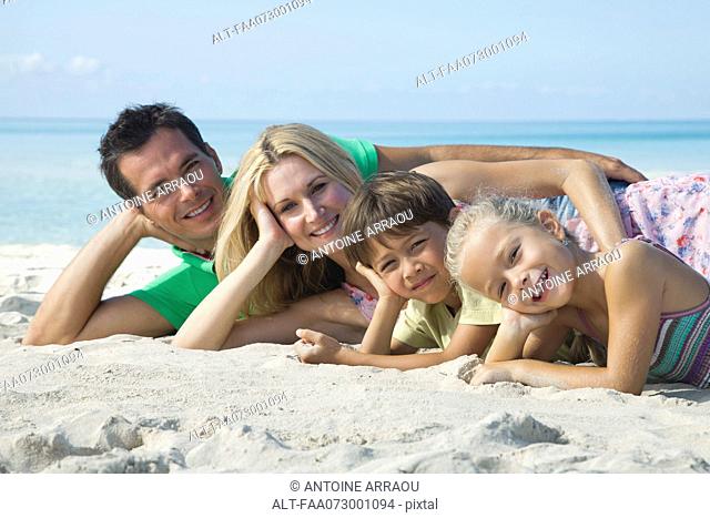 Family posing together at the beach, portrait