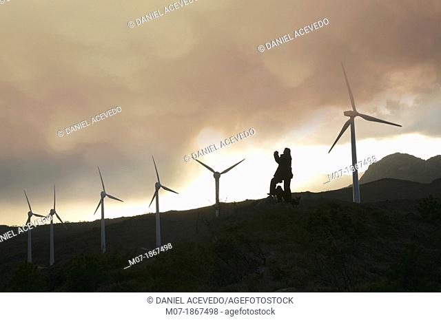 Photographer taking beautiful sunset pictures by Eolic park, wind power, wind energi, Codes mountains, Navarra, Spain, Europe