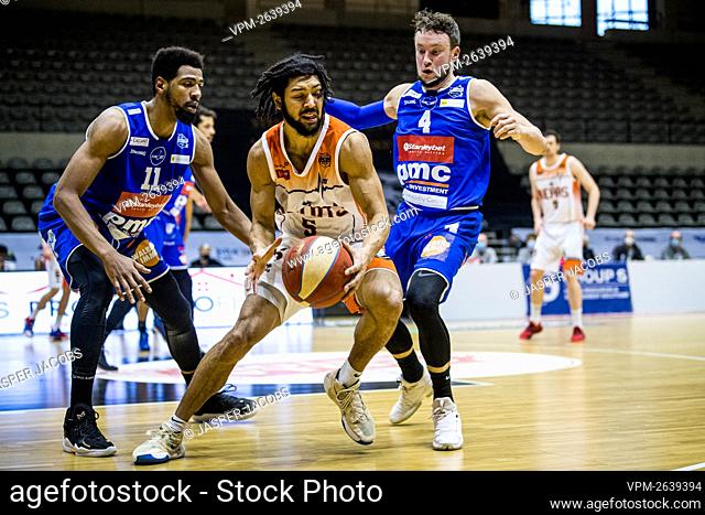 Mechelen's Rayshawn Simmons, Leuven's Joshua Heath and Mechelen's Terry Deroover fight for the ball during the basketball match between Leuven Bears and...
