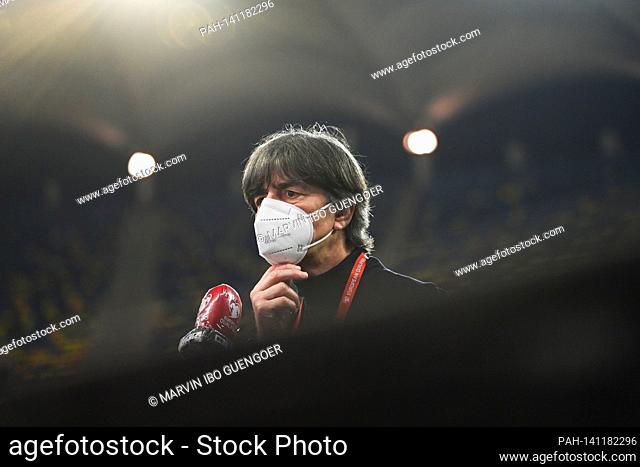 Joachim Loew, Bundescoach, (Germany) with mouth and nose protection during a TV interview. GES / Football / World Cup qualification: Romania - Germany, March 28
