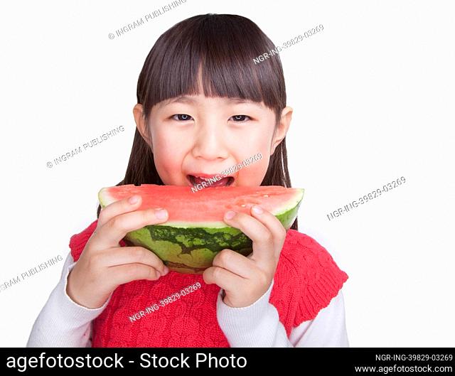 Little Girl eating watermelon, studio shot
