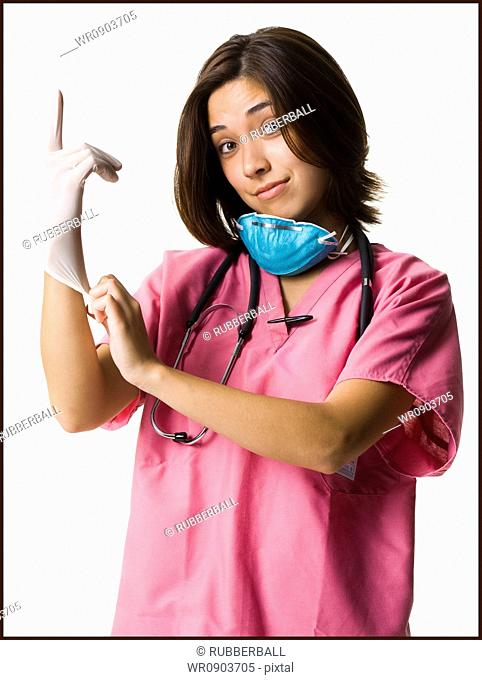 Female doctor in pink scrubs with rubber glove