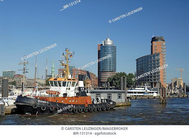 Tag boat lying in front of the modern office buildings of Hanseatic Trade Center at Kehrwiederspitze, Hamburg Harbour, Hamburg, Germany