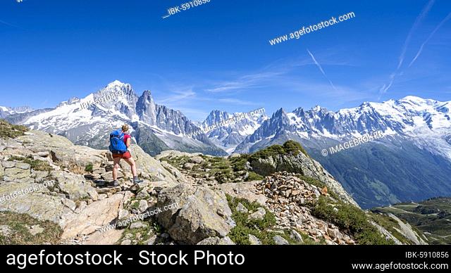 Hiker on hiking trail, Grand Balcon Sud, glacier, Mer de Glace, Aiguille Verte and Mont Blanc summits, Grandes Jorasses, Mont Blanc massif, Chamonix-Mont-Blanc