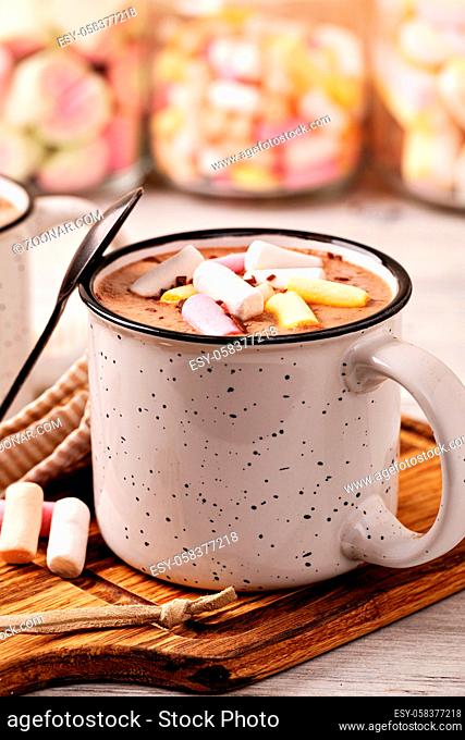 Hot chocolate with marshmallow in a cup on wooden background