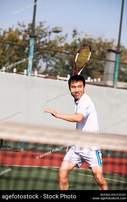 Adult men playing tennis